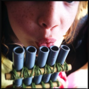 Playing home made pan pipes